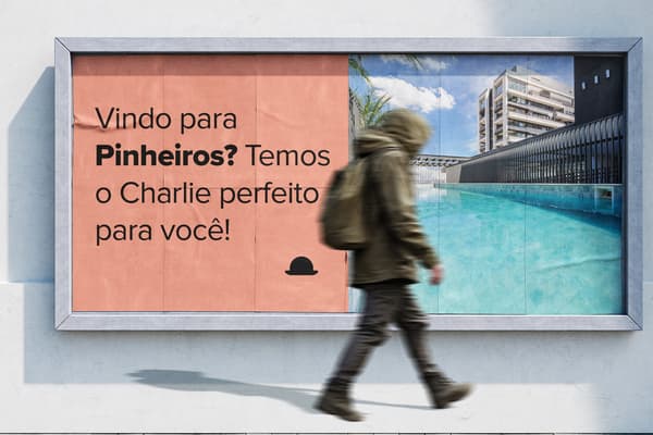 Billboard advertisement split in half. Left side has salmon background with text and a bowler hat icon. Right side shows a vibrant blue pool with loungers and a modern building. A blurred pedestrian walks in front, illustrating short and long stay in Pinheiros